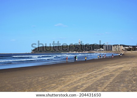 DURBAN, SOUTH AFRICA - JUNE 16, 2014: Many unknown people fish and walk along Addington beach in Durban, South Africa