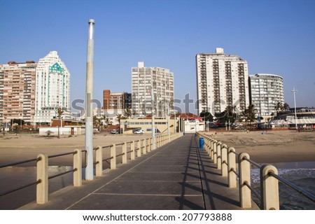 DURBAN, SOUTH AFRICA - JULY 23, 2014: View of empty pier and residential and commercial buildings on Golden Mile Beach Front in Durban, South Africa