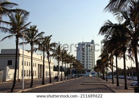 DURBAN, SOUTH AFRICA - JULY 23, 2013: Palm trees line marine parade outside former Natal Command headquarters on Golden Mile beachfront in Durban South Africa