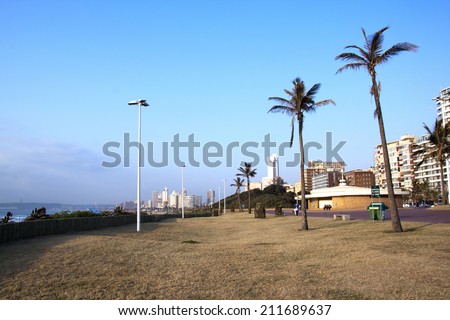 DURBAN, SOUTH AFRICA - JULY 23, 2014: Four people enjoy a quiet early morning on Golden Mile beach front in Durban, South Africa
