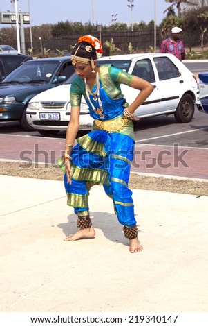 DURBAN, SOUTH AFRICA - SEPTEMBER 24, 2014: Unknown young woman  does traditional Indian dance on promenade at the Heritage Day Walk along the beachfront in Durban, South Africa.