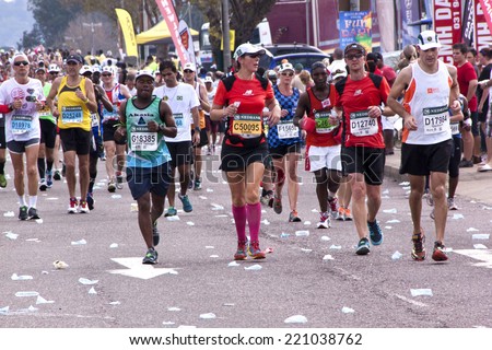 DURBAN, SOUTH AFRICA - JUNE 1, 2014: Many unknown male and female runners competing in the long distance Comrades Marathon between Pietermaritzburg and Durban in South Africa.