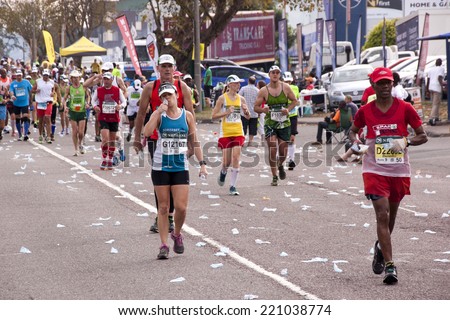 DURBAN, SOUTH AFRICA - JUNE 1, 2014: Crowd of unknown runners competing in the long distance Comrades Marathon between Pietermaritzburg and Durban in South Africa.