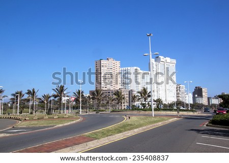 DURBAN; SOUTH AFRICA - DECEMBER 4; 2014 : Many unknown people on promenade amongst commercial and residential buildings along the \