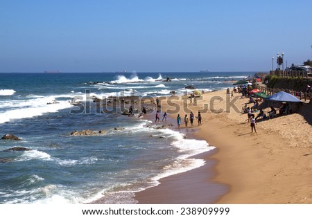DURBAN, SOUTH AFRICA - DECEMBER 18, 2014: Many unknown people on Umdloti Beach in Durban, South Africa