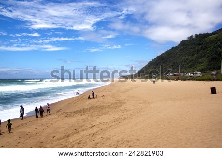 DURBAN, SOUTH AFRICA - DECEMBER 28, 2014: Many unknown people enjoy a sunny day at Brighton beach in Durban, South Africa
