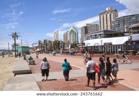 DURBAN, SOUTH AFRICA - DECEMBER 28, 2014:  Many unknown people walk and cycle along promenade on \