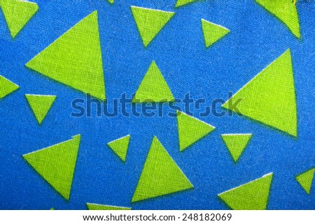 green material triangles on bright blue fabric