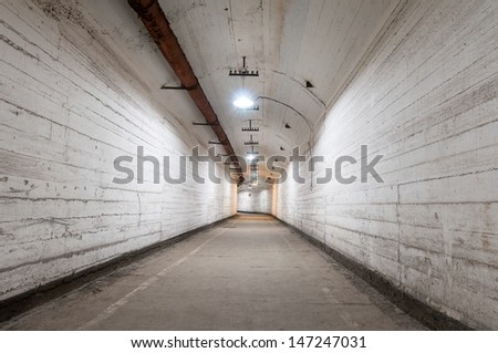 Underground tunnel with overhead lighting and overhead communica