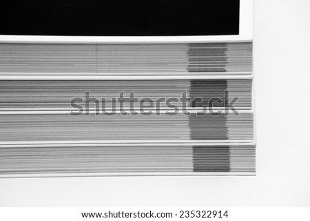 Black and white shot of a lot of books on each other, where only their edge is visible