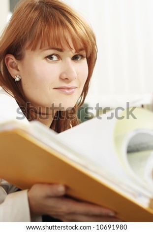 Woman in office search a file