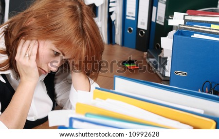 A woman looks tired, stress in office