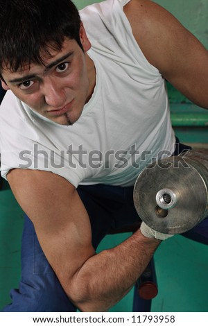 Young man works out with free weights