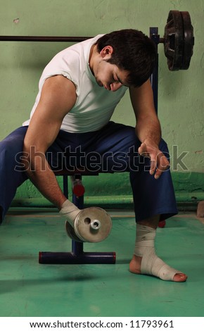 Young man works out with free weights
