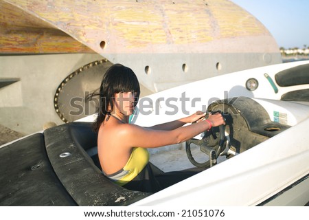 Young woman driving the boat