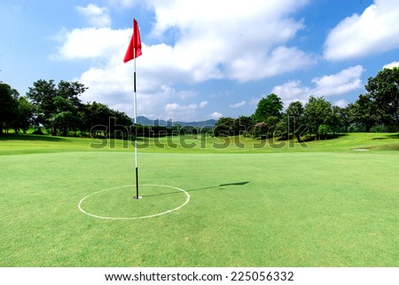 Golf course with flag and beautiful sky
