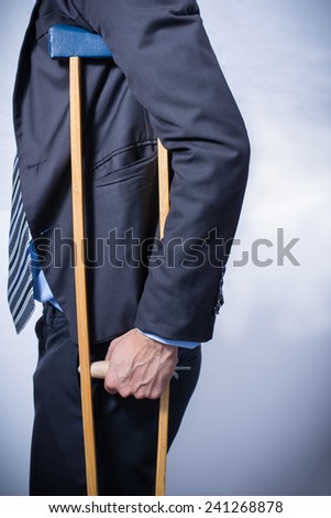 businessman with crutches, white background. Disabled person in work.