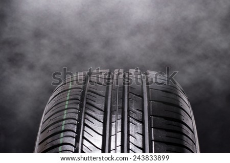 Tire Car with smoke on black background