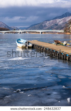 boat on lake water Change the frozen lake at lake kawaguchiko winter, Japan