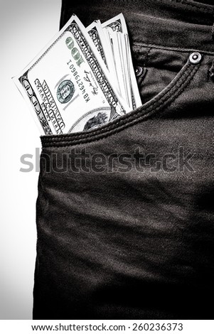 pocket pants stuffed with 100 Dollar bill