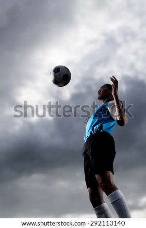 football player in jump action striking of the ball