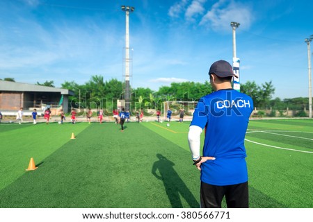blurred image ofCoach is coaching Children Training In Soccer Team