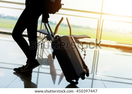 Departure lounge at the airport with traveller and luggage