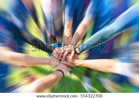Blurred image of Soccer players putting their hands together Join team energy for power that makes winners