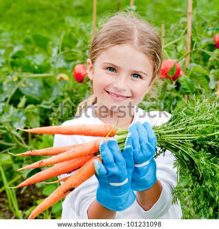 Vegetable garden - lovely gardener with bunch of carrots