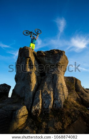 Mountain biker riding on bike in summer mountains forest landscape. Man cycling MTB. Outdoor sport activity.