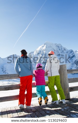 Winter, snow, sun and fun - family enjoying winter vacations (space for text)