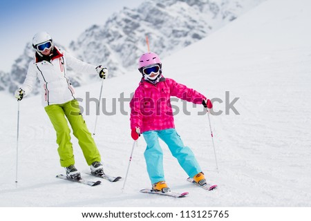 Skiing, winter, ski lesson - kid with mother on mountainside