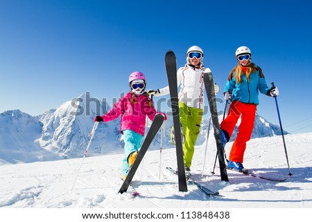Skiing winter happy skiers on mountainside Skiing winter happy skiers on mountainside