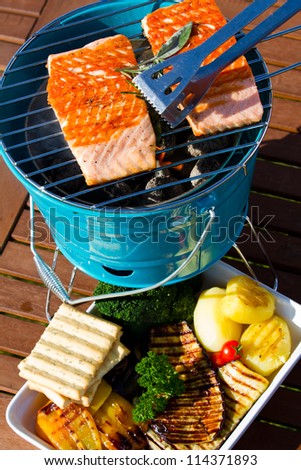 Grilled  salmon and grilled vegetables, grilling in the garden. Delicious healthy eating.