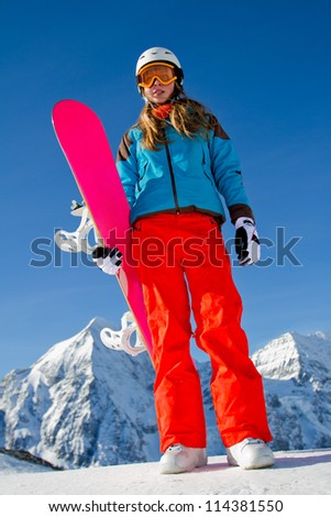 Winter, snowboarding - portrait of young snowboarder girl