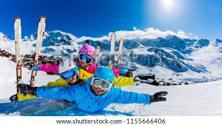 Happy family enjoying winter vacations in mountains, Val Thorens, 3 Valleys, France. Playing with snow and sun in high mountains. Winter holidays.