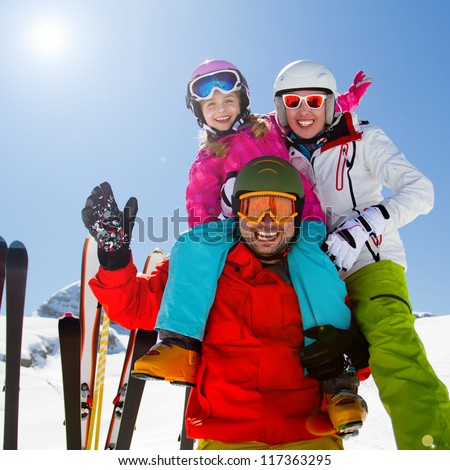 Skiing, winter fun - happy family on ski holiday
