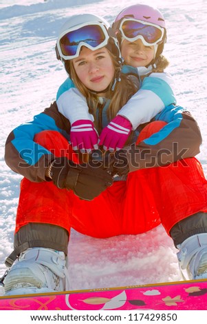 Snowboarding, winter sports - young snowboarders having fun on winter vacation
