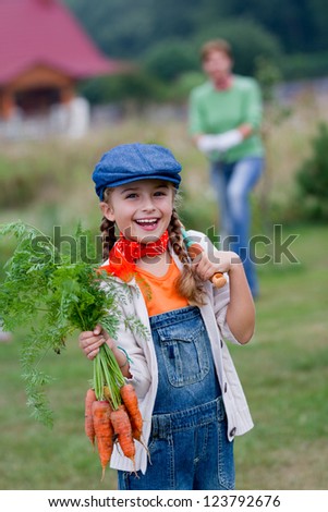 Gardening, gardener, kid - lovely girl working in vegetable garden