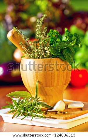 Fresh herbs in the mortar - healthy food, alternative medicine