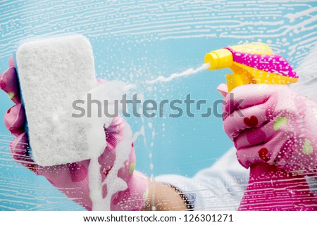 Cleaning - cleaning window pane with spray detergent, spring cleaning concept