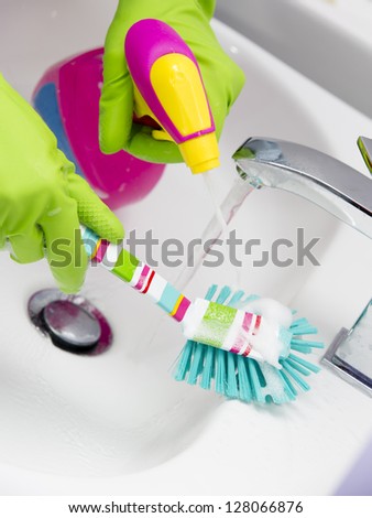 Cleaning - cleaning bathroom sink with spray detergent - housework, spring cleaning concept