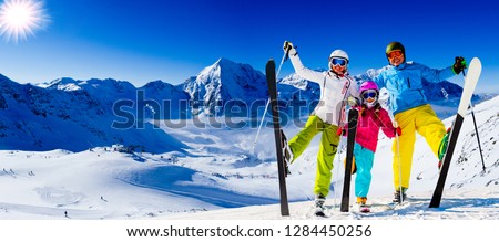 Happy family enjoying winter vacations in mountains. Playing with snow, Sun in high mountains. Winter holidays.