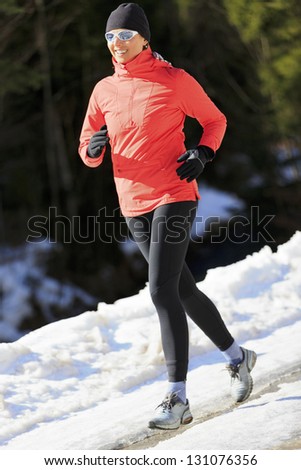 Runner, spring running, exercise woman. Jogging on early spring in mountains. Healthy lifestyle concept.
