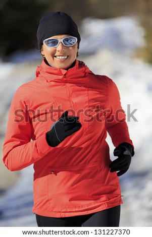 Runner, spring running, exercise woman. Jogging on early spring in mountains. Healthy lifestyle, active woman concept.