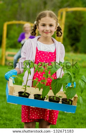 Gardening, garden, planting concept - lovely gardener working with mother in the garden