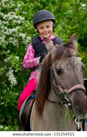 Horse riding - lovely equestrian is riding on a horse