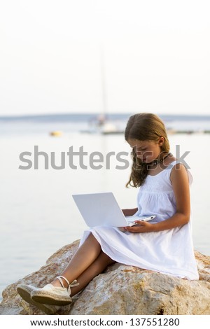 Girl with netbook - Lovely girl with netbook resting on the beach