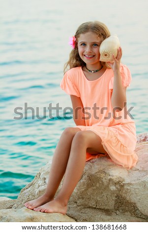 Summer beach, beach resort, summer joy - lovely girl with shell at the beach