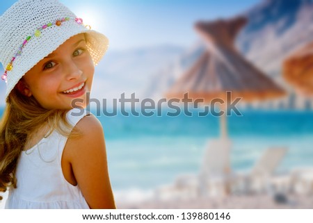 Lovely Girl On Tropical Beach,Beach Chair And Umbrella In Background